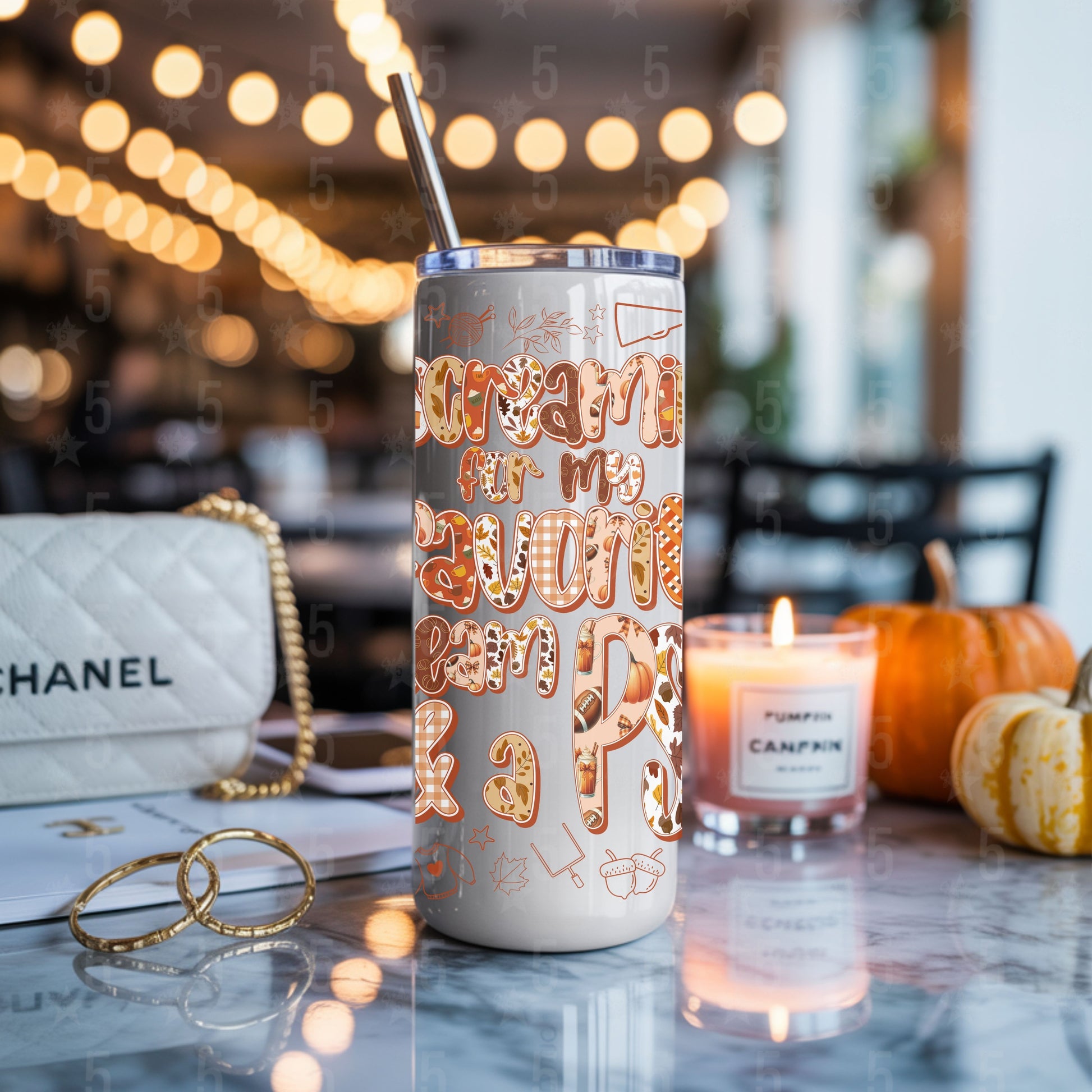 Tumbler with decorative text on a table with a blurred background