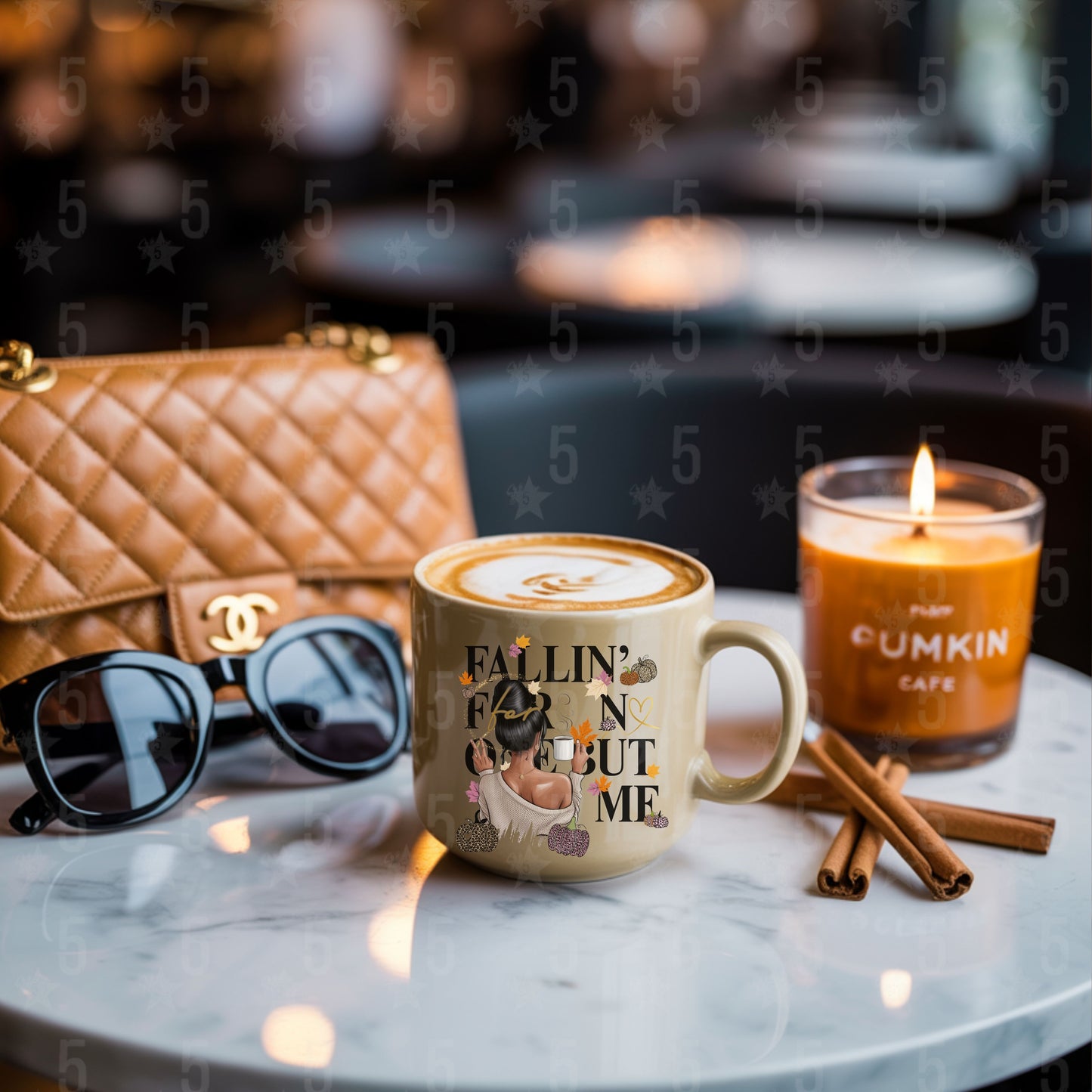 Café setting with a mug, candle, sunglasses, and cinnamon sticks on a marble surface.