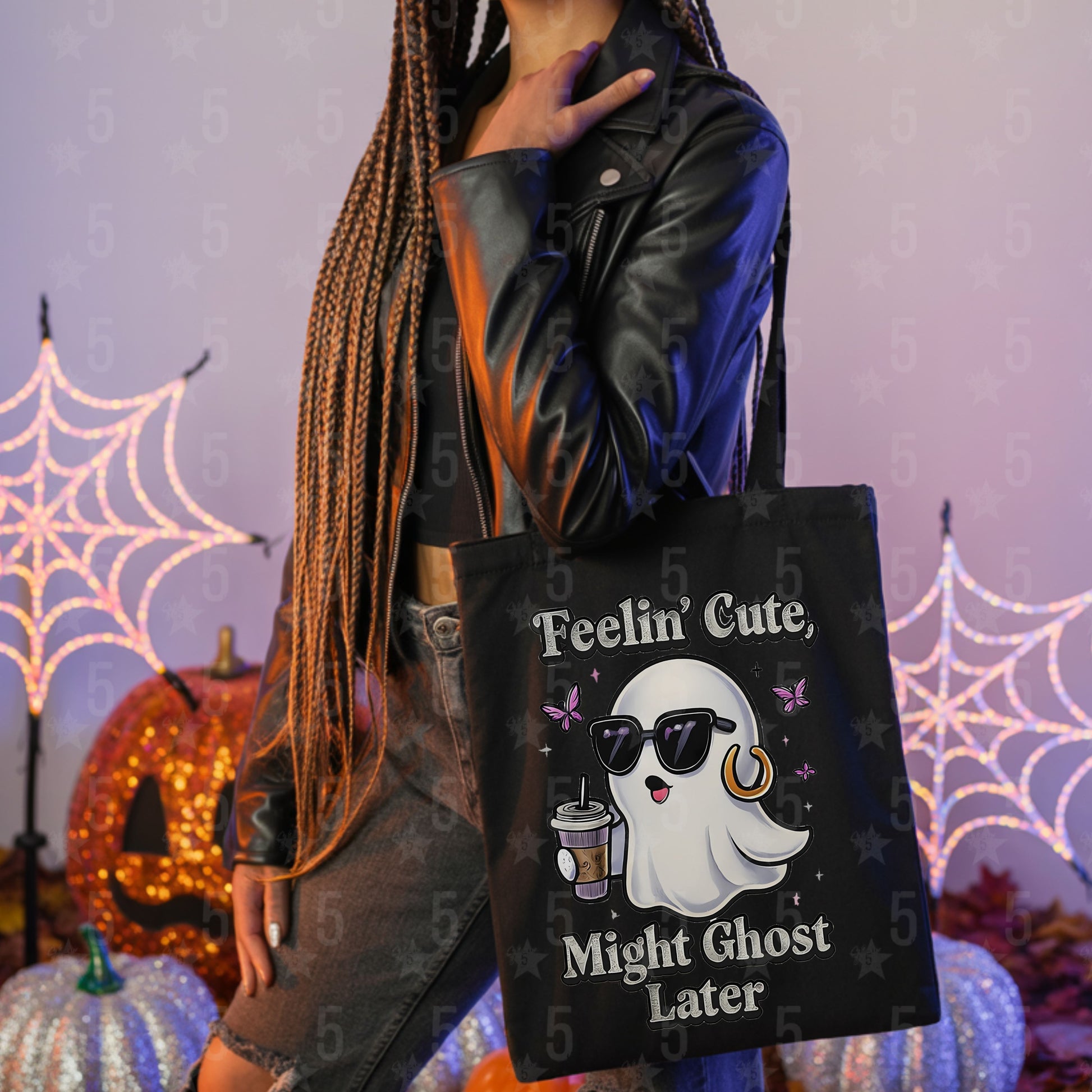 Person holding a black tote bag with a ghost design and text in a Halloween-themed setting.