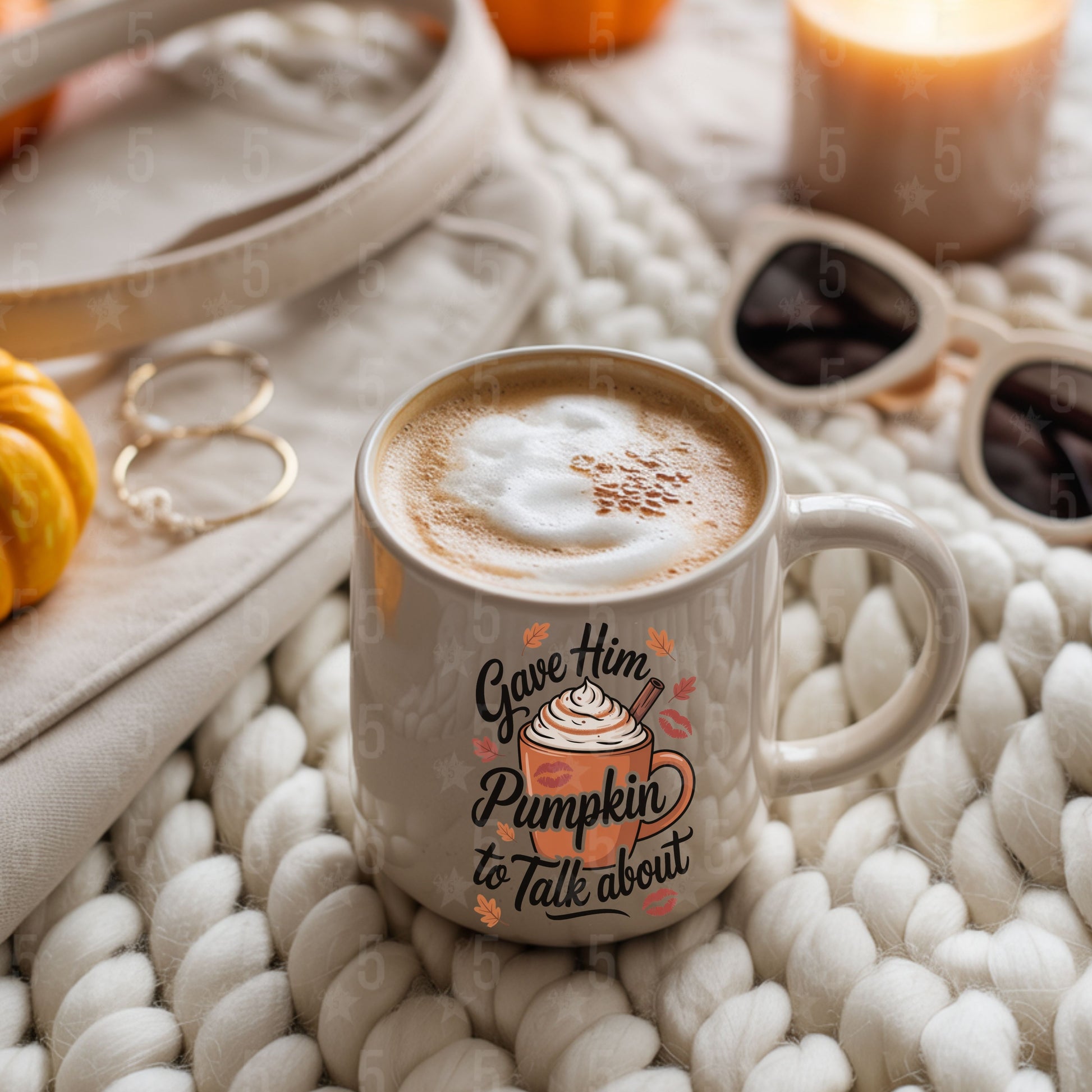 Mug with pumpkin spice latte and decorative text on a cozy surface with pumpkins and candles.