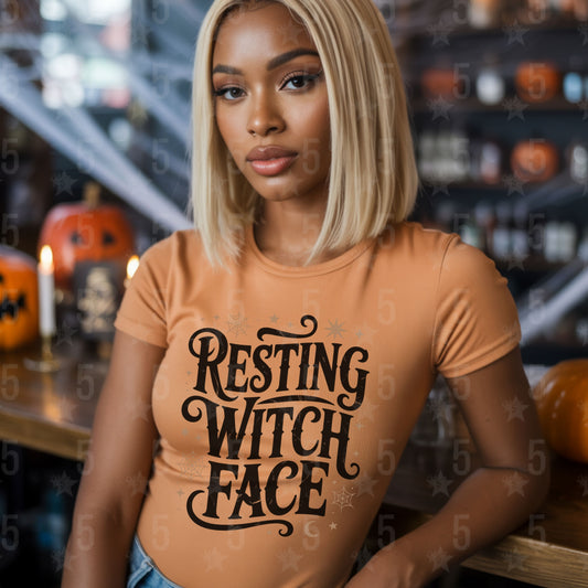 Woman wearing a 'Resting Witch Face' shirt in a Halloween-themed setting