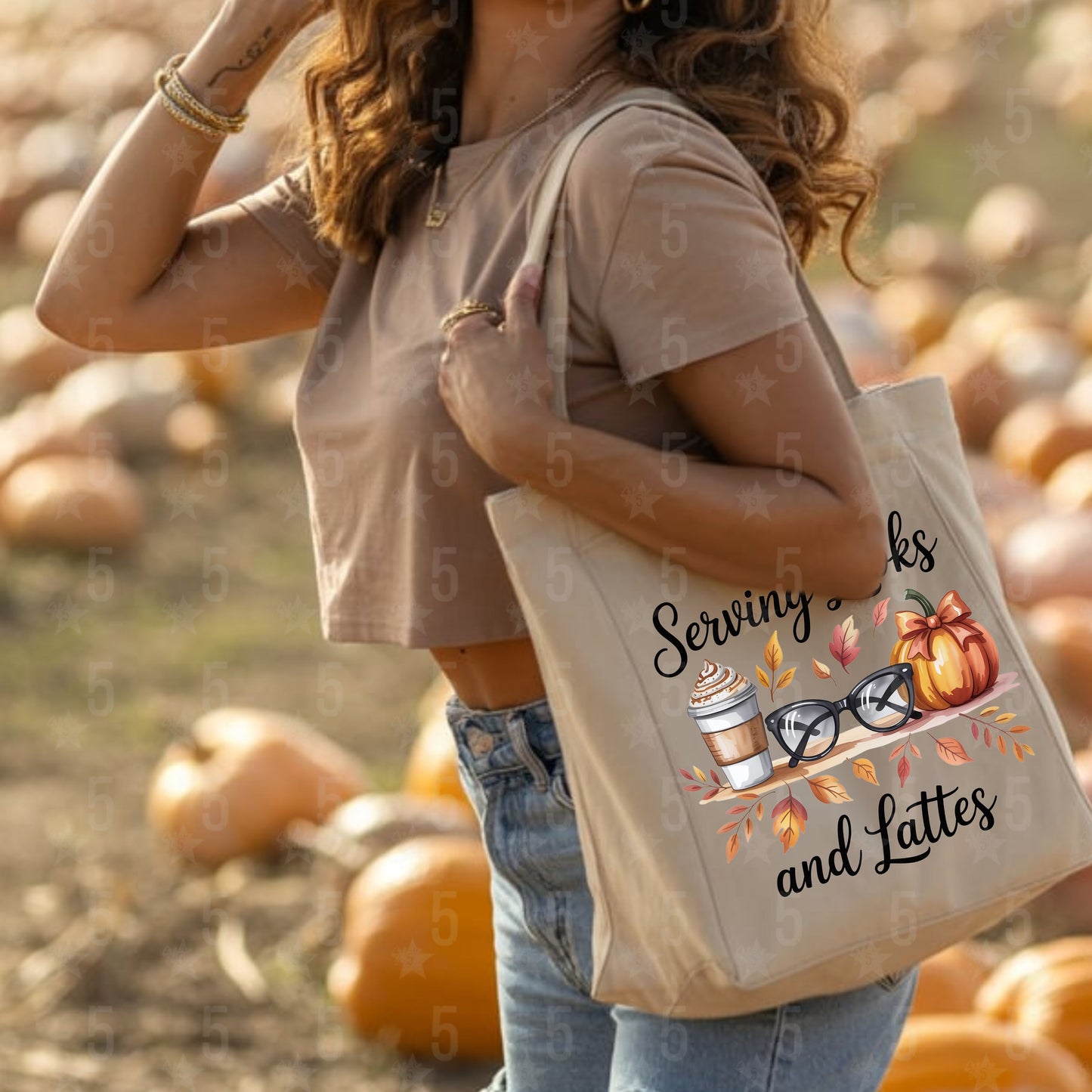 Person holding a tote bag with 'Serving Sacks and Lattes' design in a pumpkin patch.
