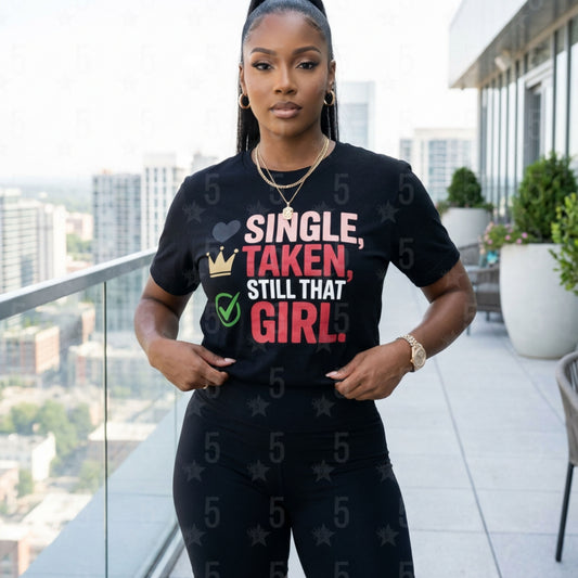 Woman wearing a black t-shirt with colorful text on a balcony with cityscape background