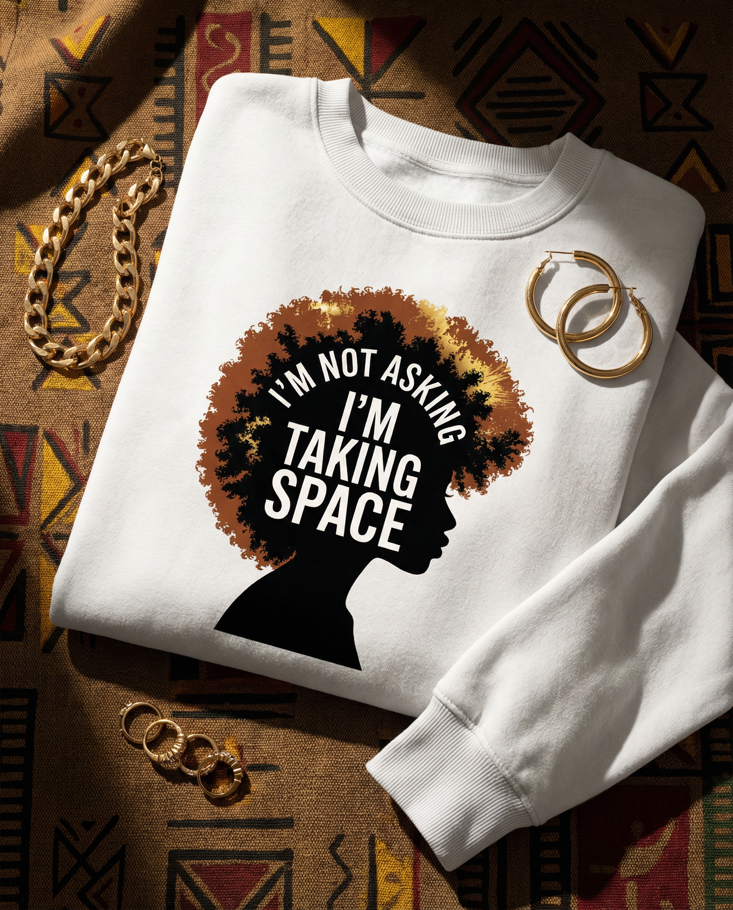 White sweatshirt with a graphic design and text on a patterned fabric background