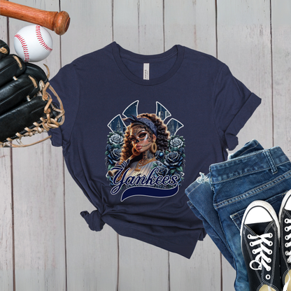 Navy blue t-shirt with dia de los muertos 'Yankees' design, baseball, bat, glove, and jeans on a wooden surface