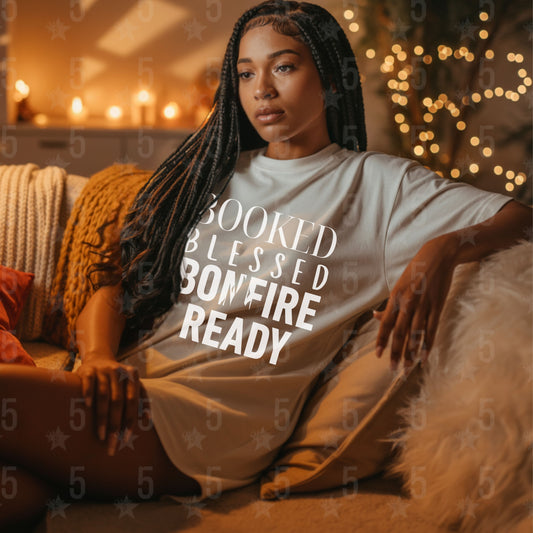 Woman wearing a t-shirt with text sitting on a couch in a cozy room.