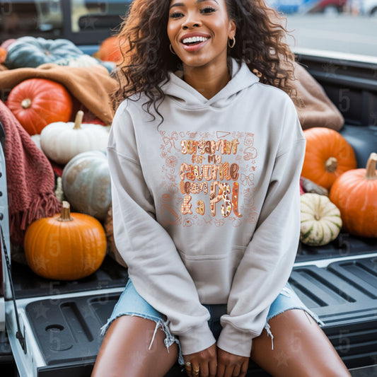 Woman wearing a hoodie with a pumpkin patch background