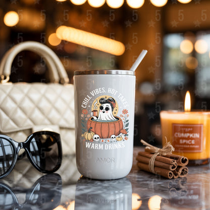 coffee tumbler surrounded by cinnamon sticks, candles, chanel bag and sunglasses