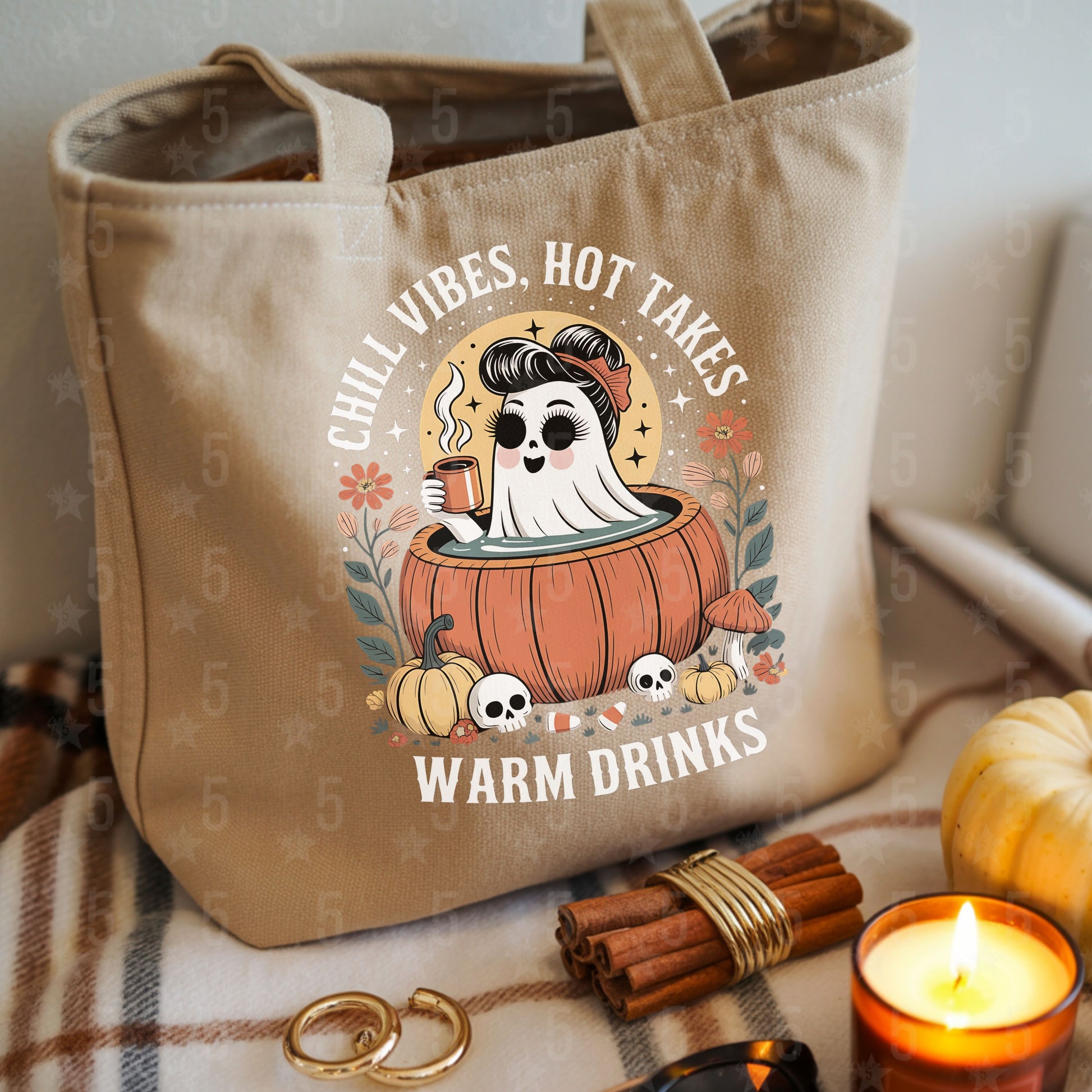 beige canvas tote bag surrounded by gold hoops, cinnamon sticks and a candle