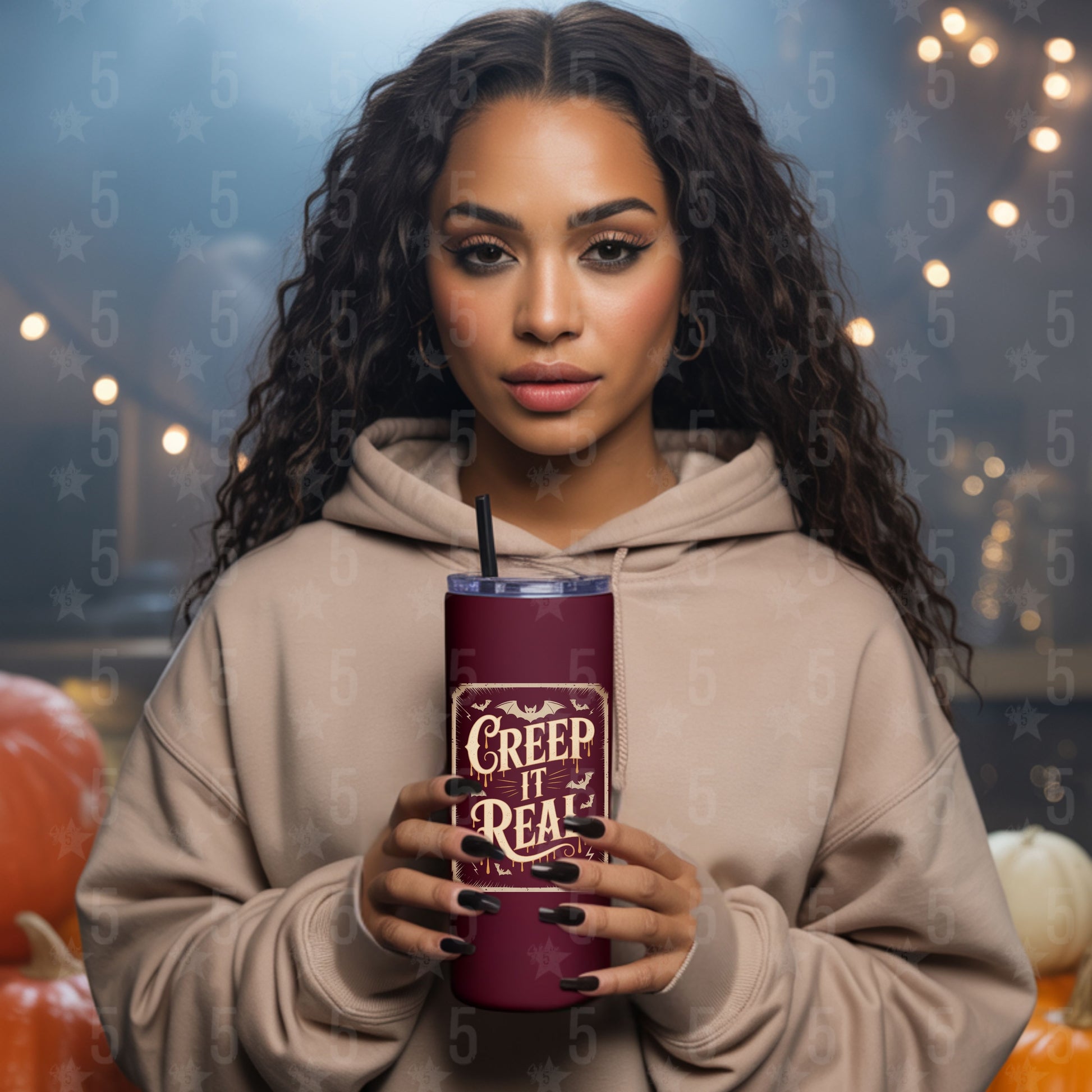 Woman holding a purple tumbler with Halloween text, surrounded by pumpkins and blurred lights.