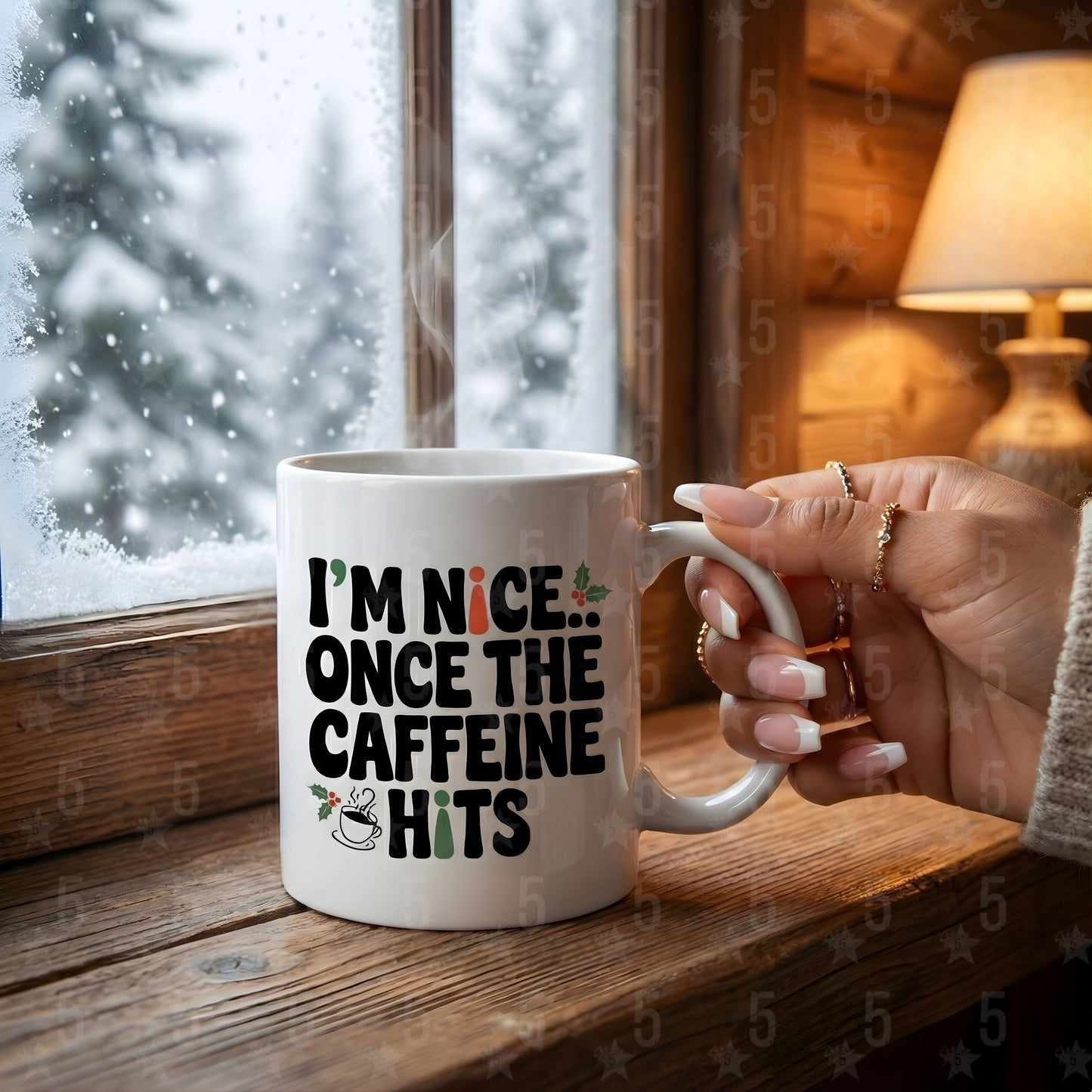 Person holding a mug with 'I'm nice... once the caffeine hits' text by a window with snow outside.