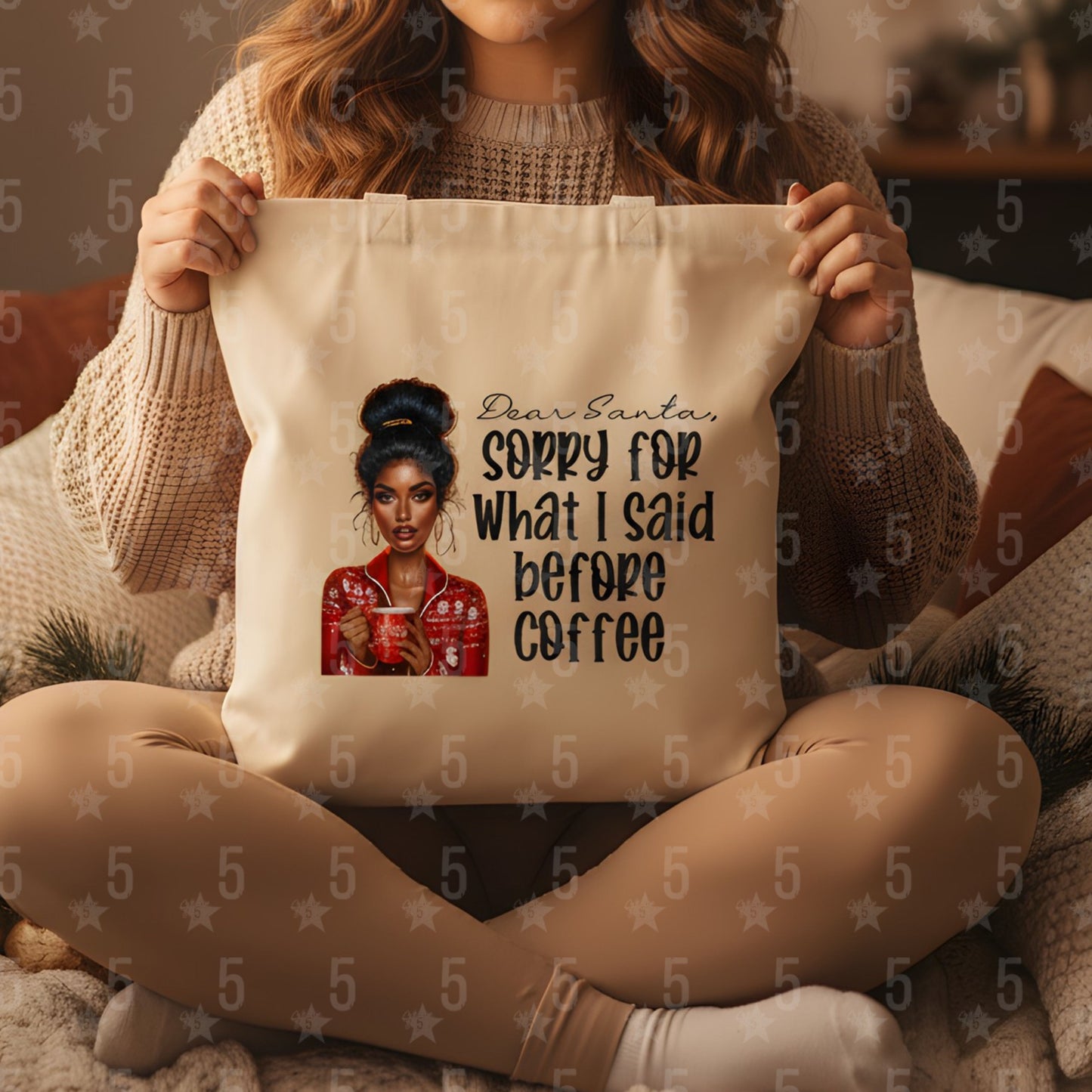Person holding a tote bag with a graphic of a woman and text, sitting on a couch.