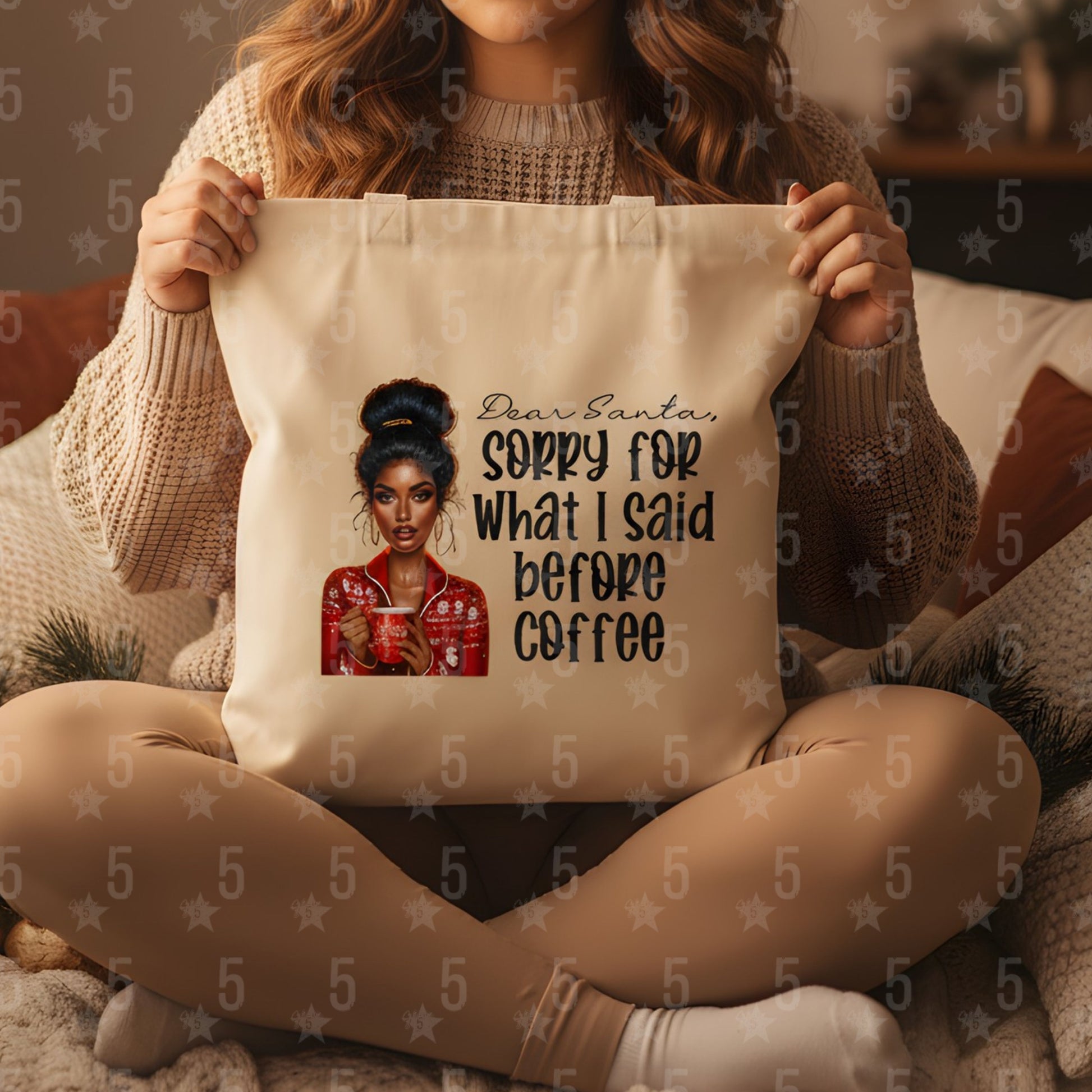 Person holding a tote bag with a graphic of a woman and text, sitting on a couch.