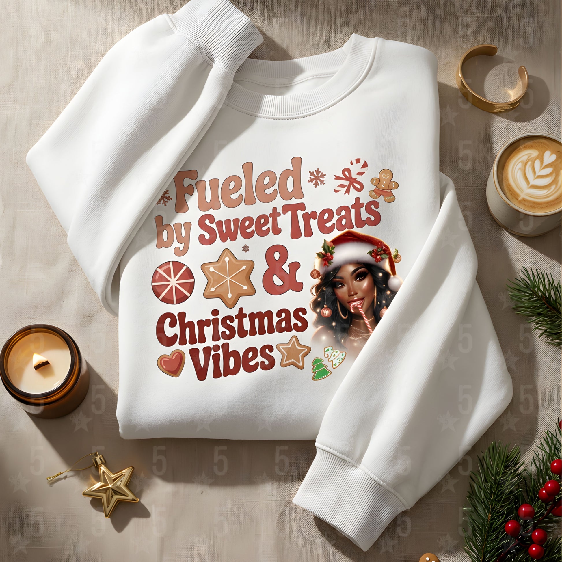 White sweatshirt with Christmas-themed design and text on a decorative surface with candles and ornaments.
