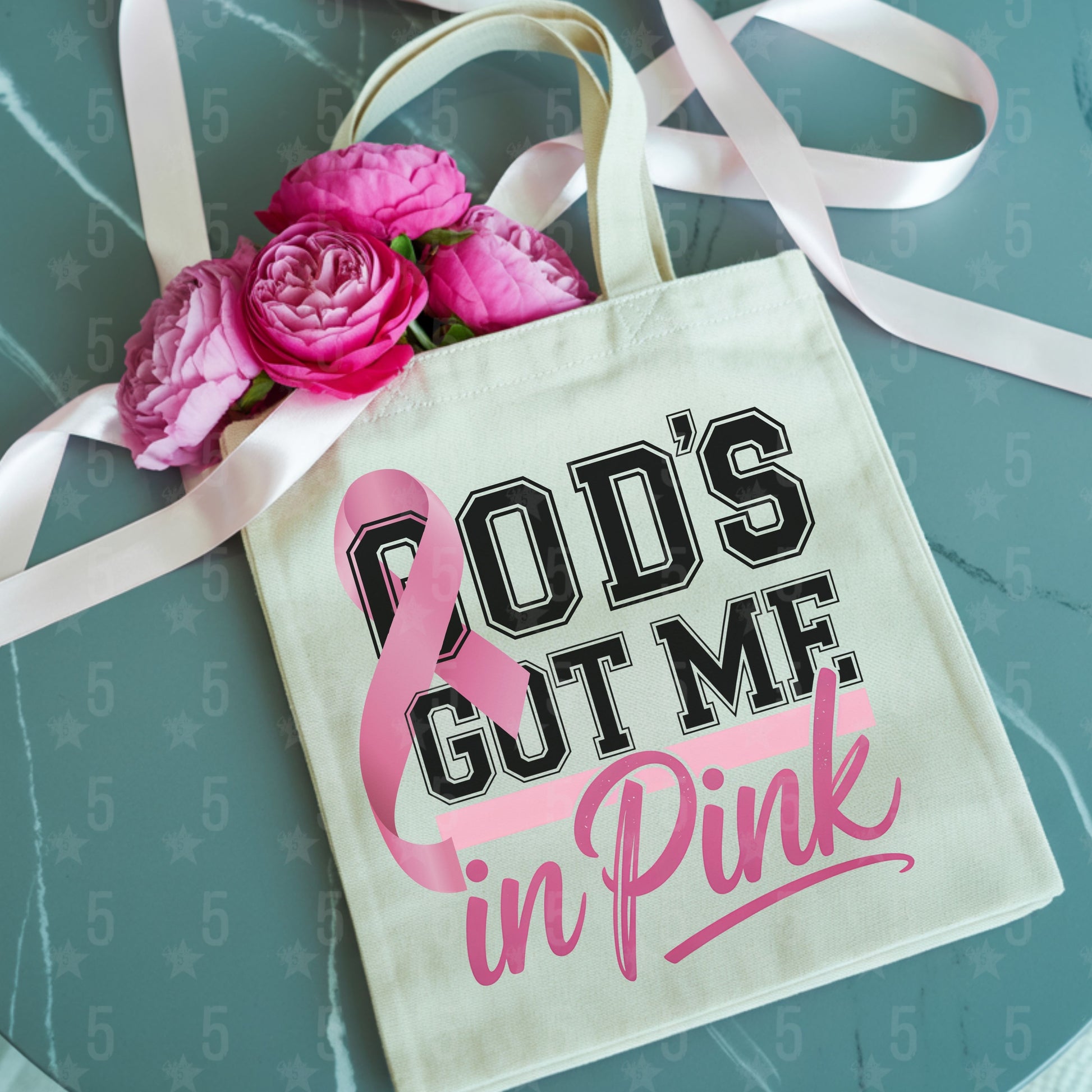 Tote bag with 'God's Got Me in Pink' text and pink roses on a teal background