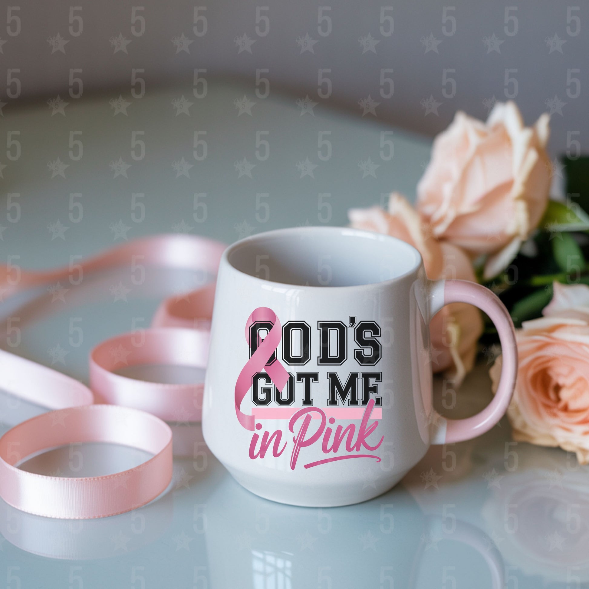 White mug with 'God's got me in pink' text and pink roses on a light background