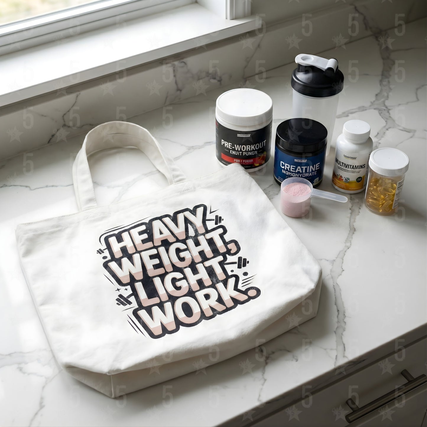 Tote bag with 'Heavy Weight Light Work' text on a marble surface with health supplements.