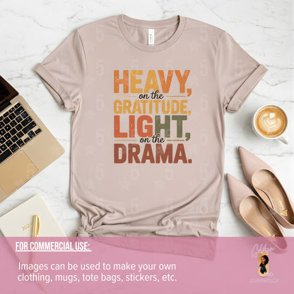 Beige t-shirt with motivational quote on a white surface with laptop, shoes, and coffee.