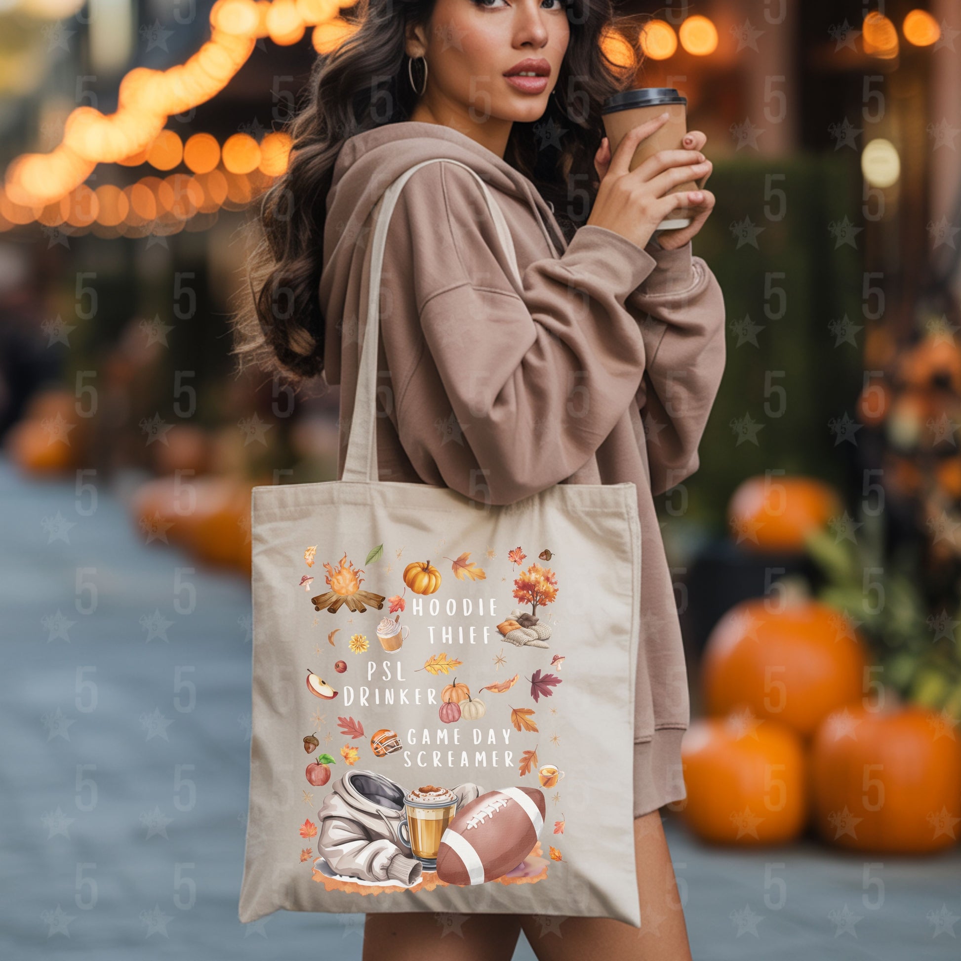 Woman holding a coffee cup and a tote bag with autumn-themed design in an outdoor setting with pumpkins.