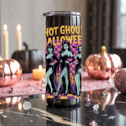 Halloween-themed tumbler with graphic design on a decorative table with pumpkins and candles.