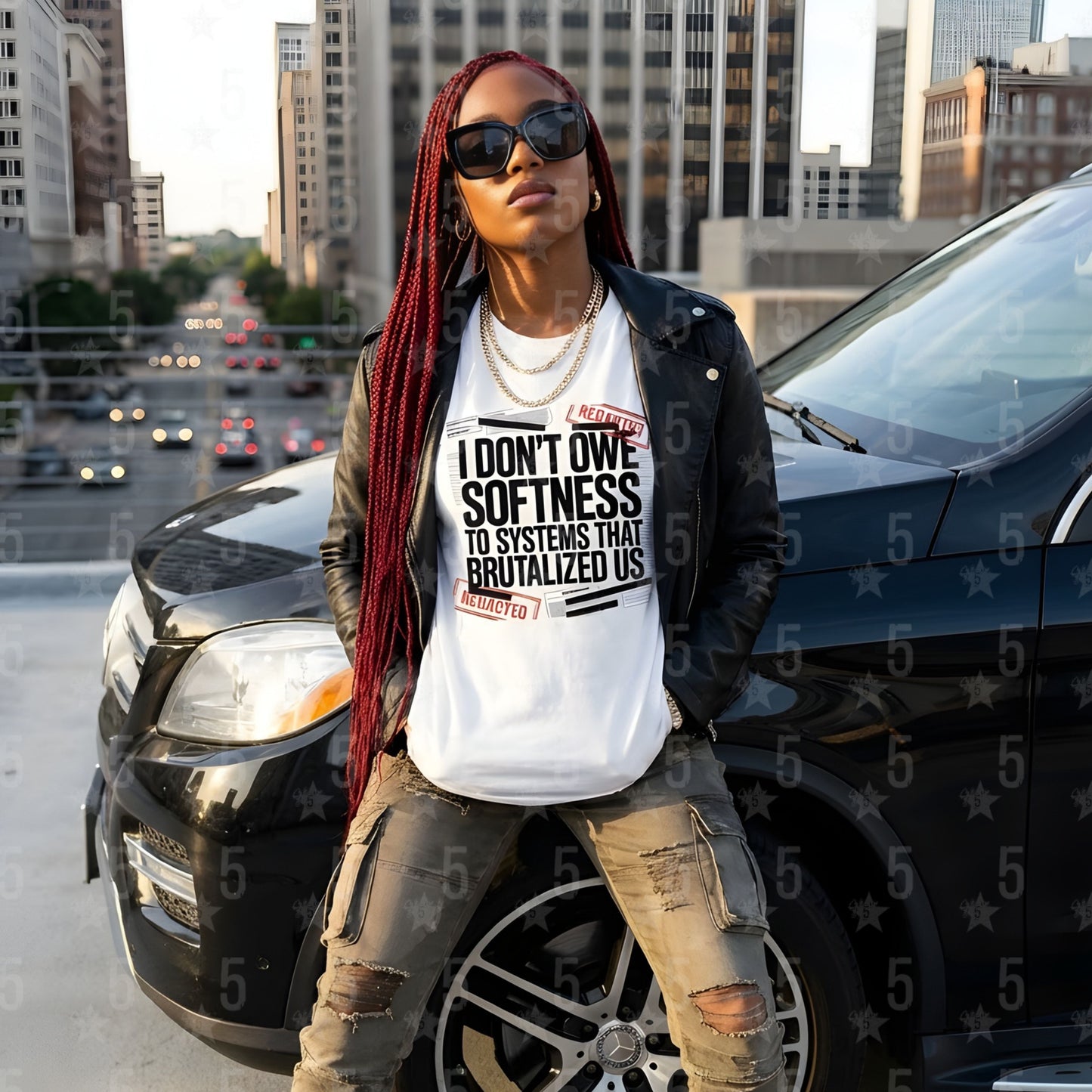 Person wearing a white t-shirt with text, standing next to a car in an urban setting