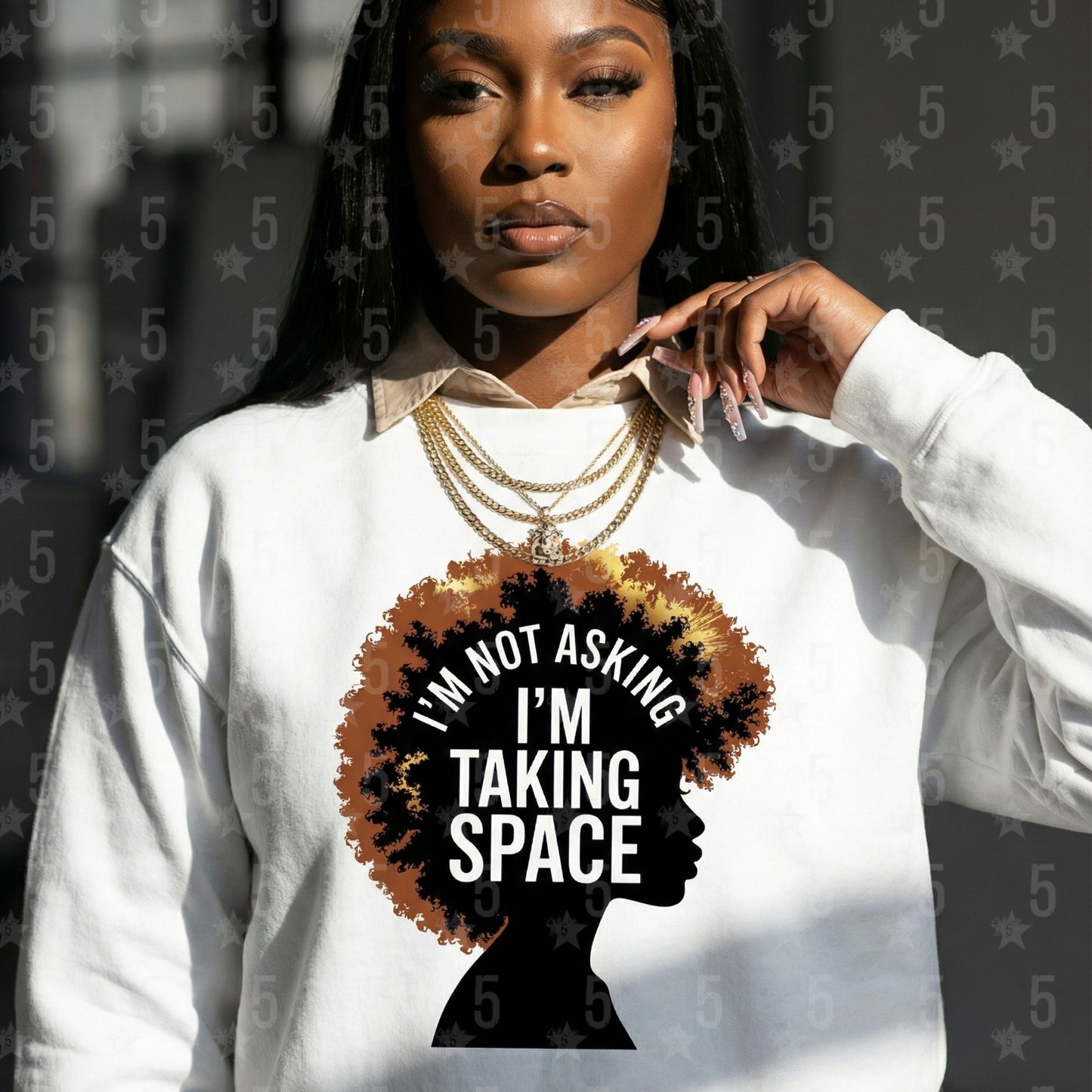 Woman wearing a white sweatshirt with a graphic and text 'I'm not asking, I'm taking space' on a dark background.