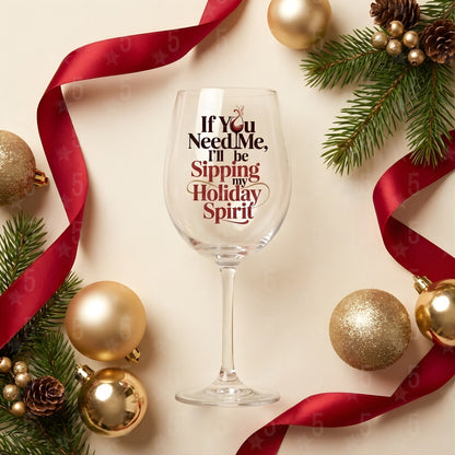 Wine glass with humorous text surrounded by Christmas decorations on a light background