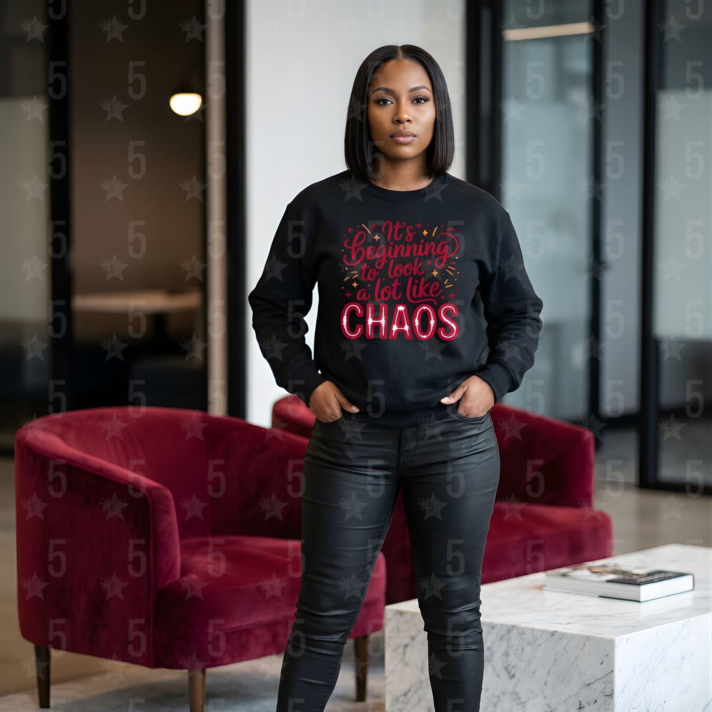 Person wearing a black sweatshirt with red text in a modern indoor setting