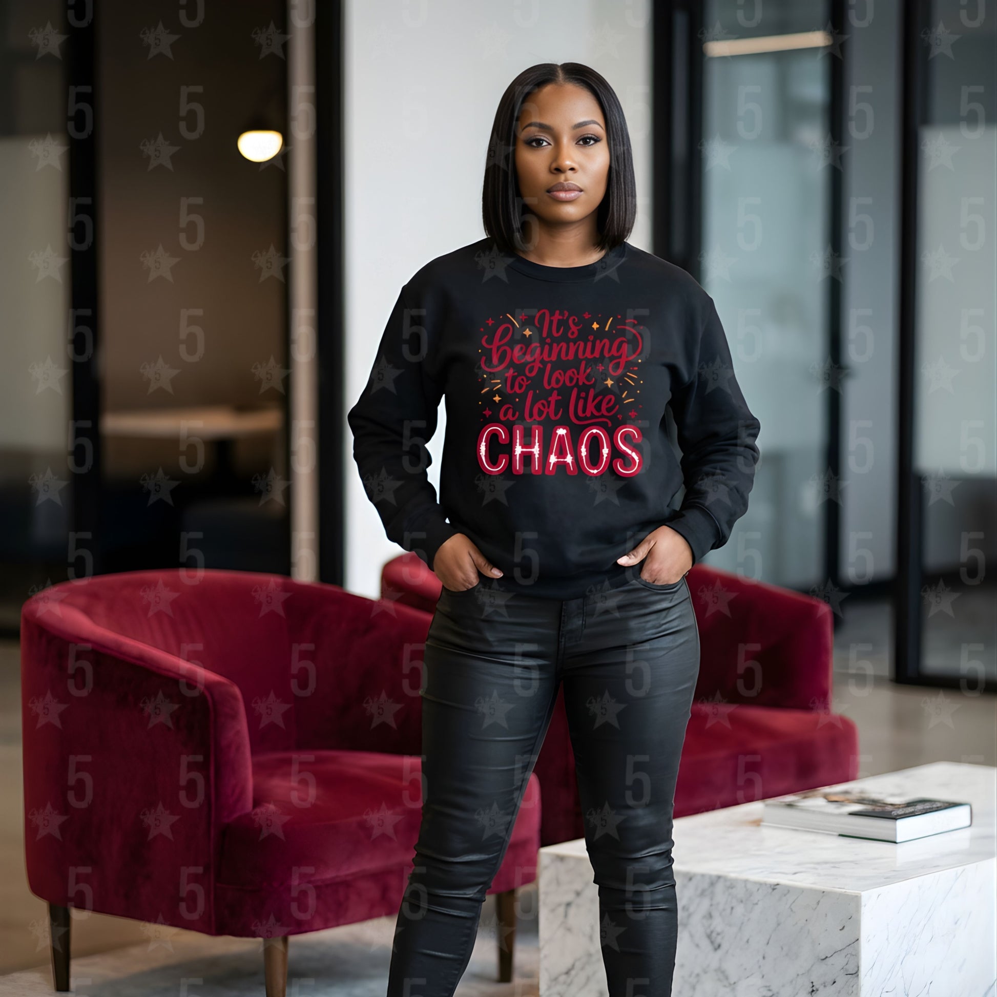 Person wearing a black sweatshirt with red text in a modern indoor setting