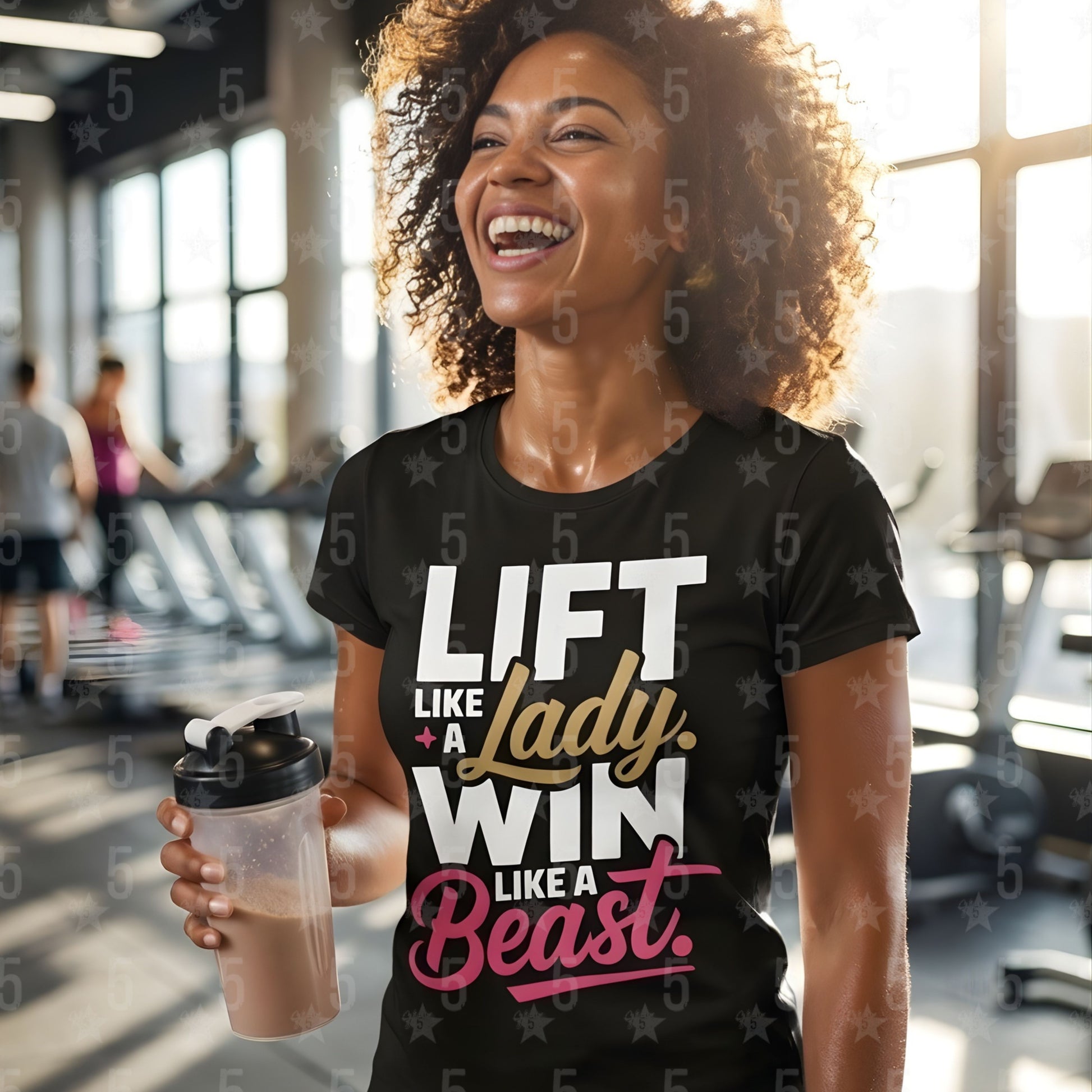 Woman in a gym wearing a black t-shirt with motivational text, holding a protein shake container.