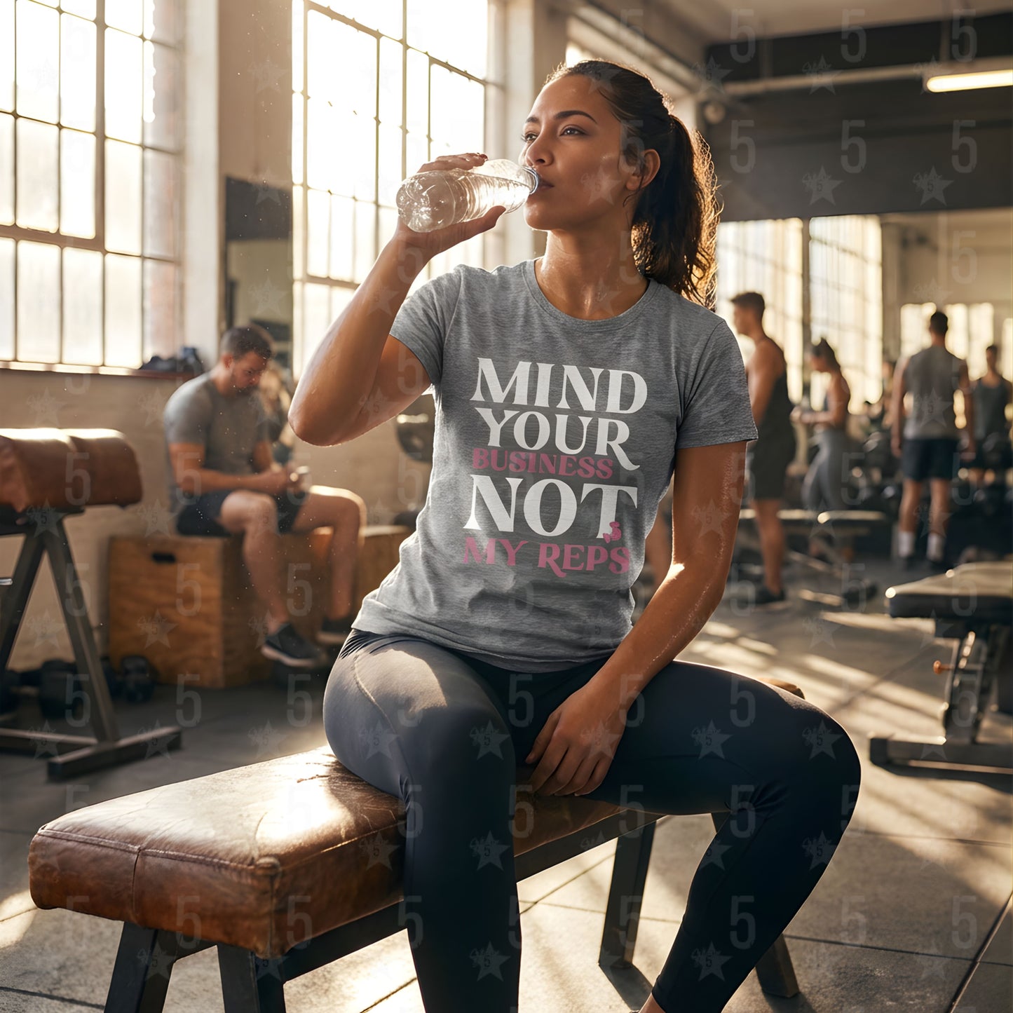 A woman sipping water in the gym