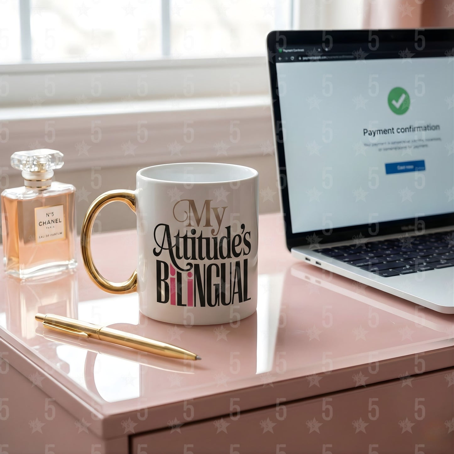 Mug with 'My Attitude's Bilingual' text on a desk next to a laptop and perfume bottle.