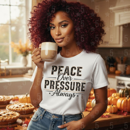 Woman holding a mug in a kitchen with 'Peace Over Pressure Always' shirt