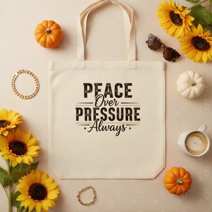 Tote bag with 'Peace Over Pressure Always' text, surrounded by sunflowers, pumpkins, and a cup on a beige background.