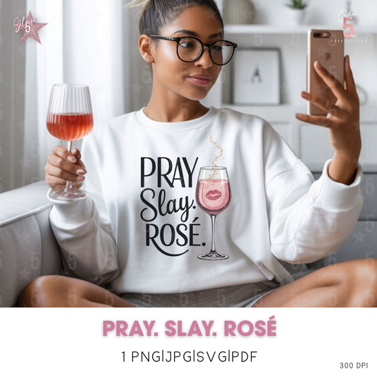 Woman wearing a 'Pray. Slay. Rosé' sweatshirt, holding a glass of rosé and a phone.