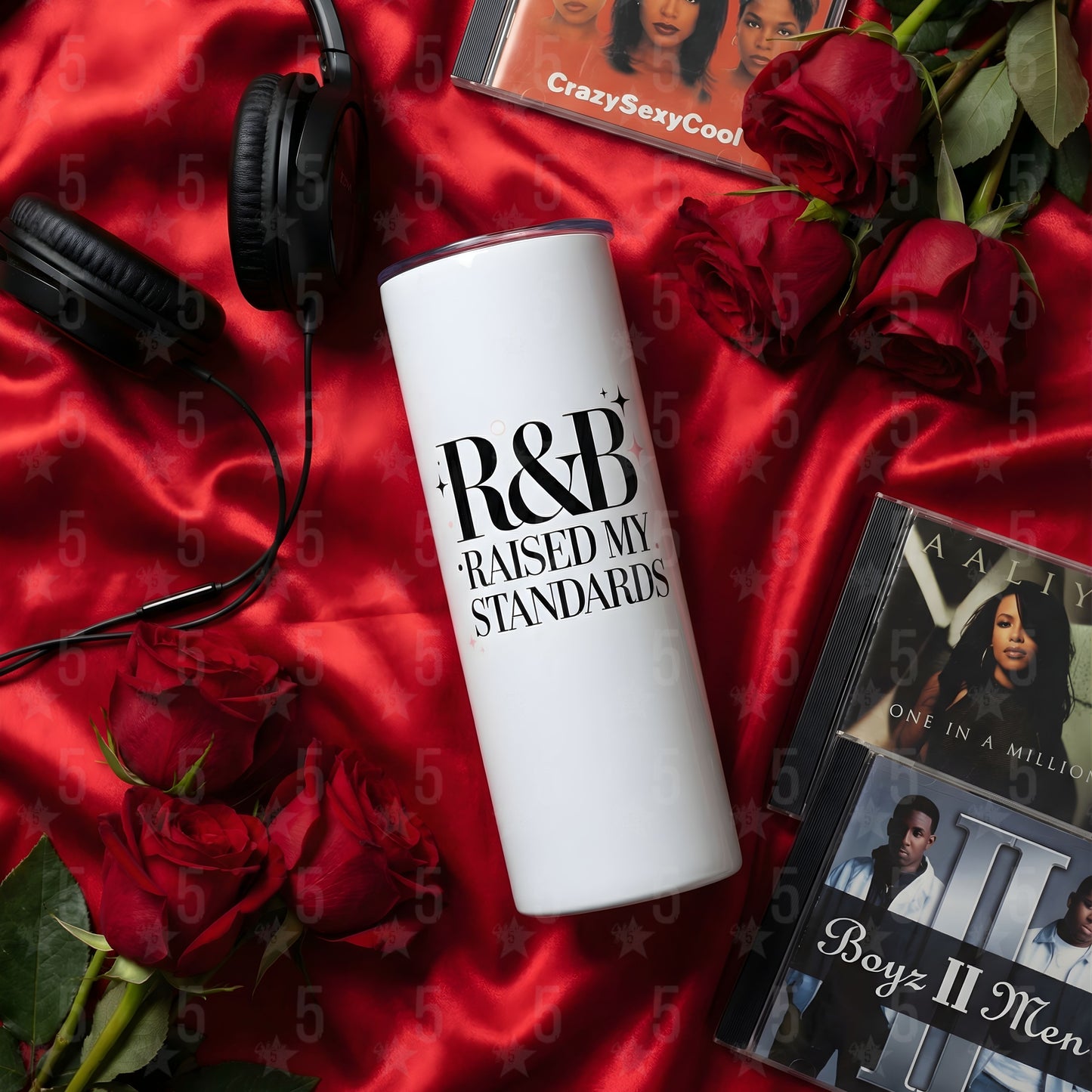 White tumbler with 'R&B Raised My Standards' text on a red fabric background with roses and music albums.