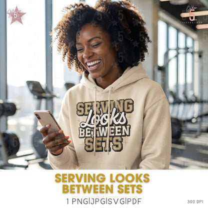 woman at the gym looking at her phone wearing a beige hoodie