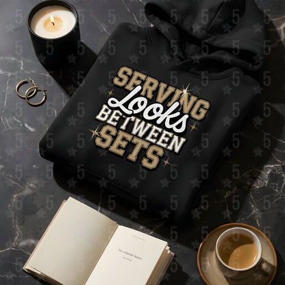 A black. fitness hoodie laid flat on a marble surface