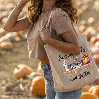 Person holding a tote bag with 'Serving Sacks and Lattes' design in a pumpkin patch.