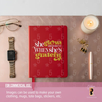 Red notebook with motivational quote on a desk with glasses, watch, candle, and pen.