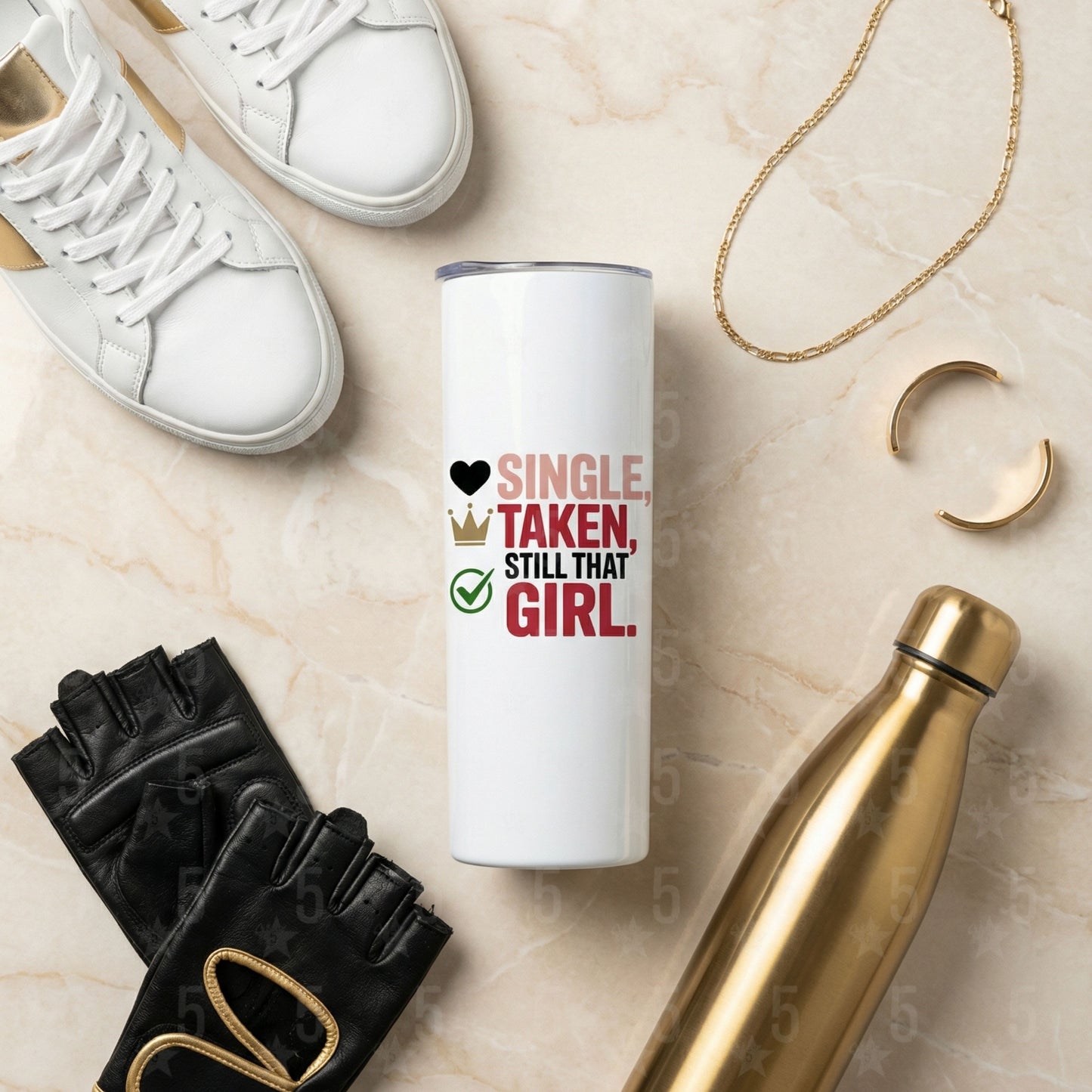 White tumbler with text, white sneakers, black gloves, gold chain, and gold water bottle on a beige surface