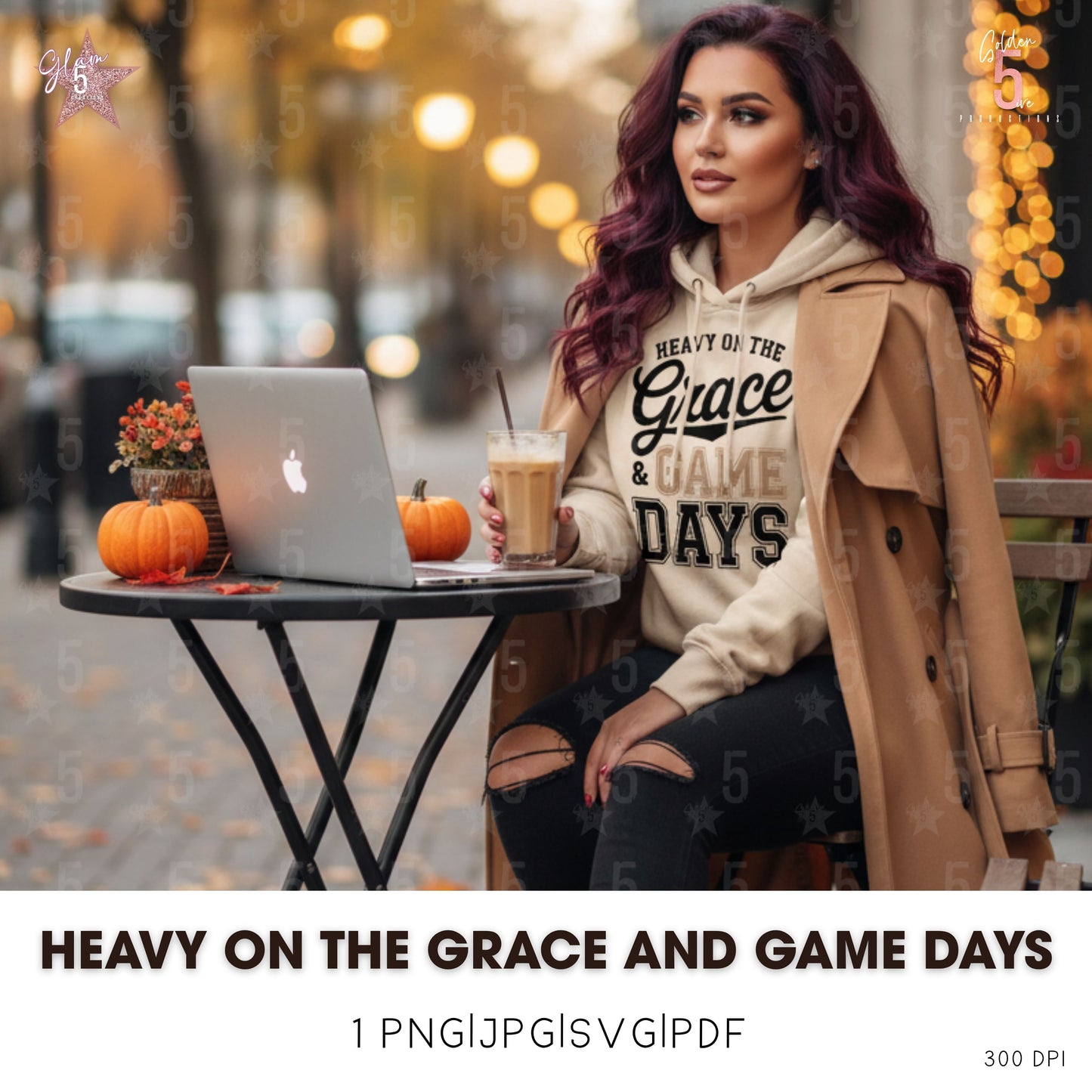Woman sitting at a table with a laptop and pumpkin decorations, wearing a hoodie with text.