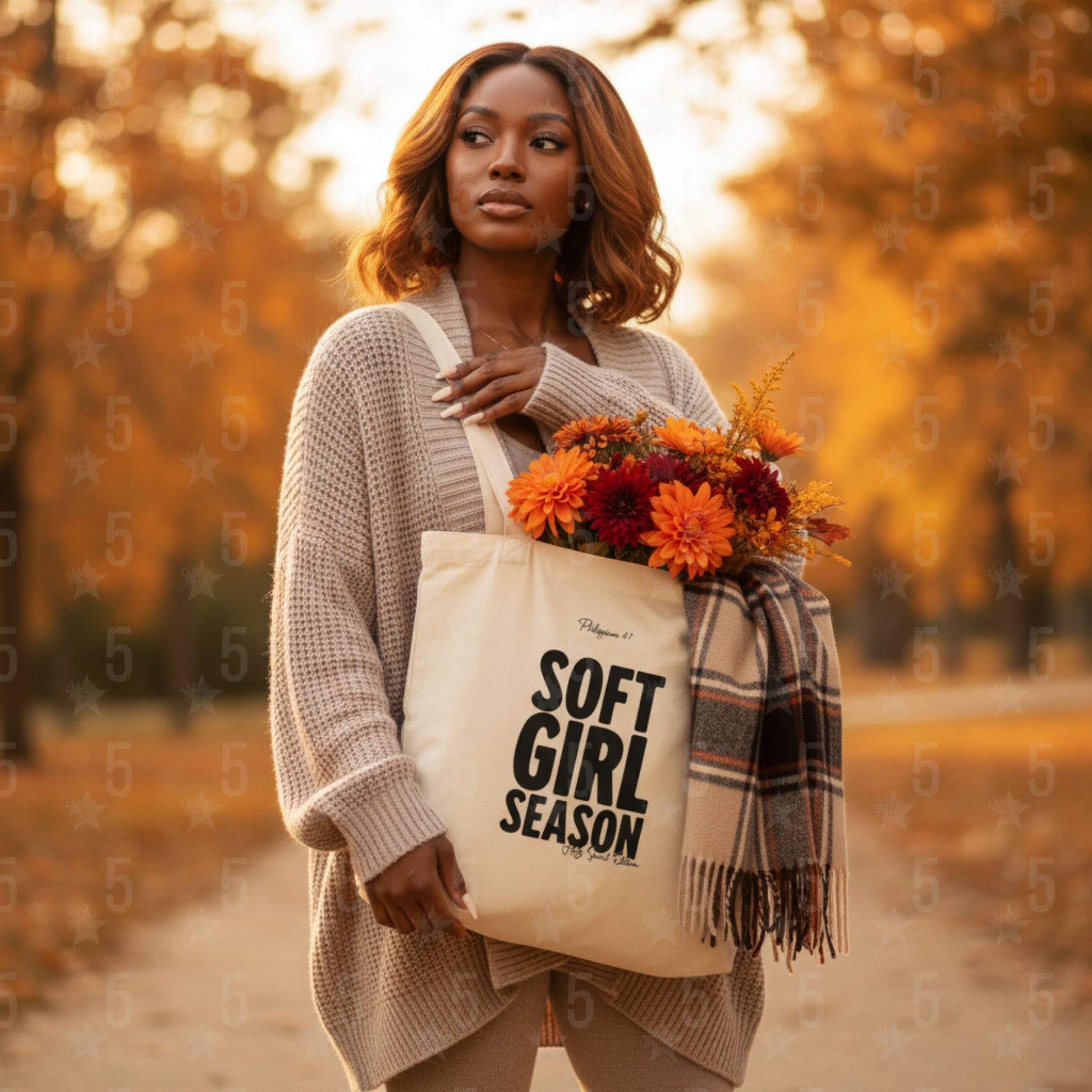 Woman holding a bouquet of flowers and a tote bag with 'Soft Girl Season' text in an autumn setting.