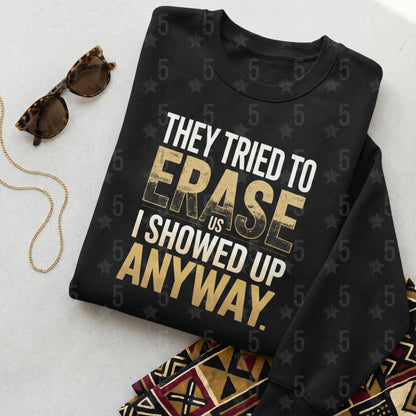 Black sweatshirt with text 'They tried to erase us, I showed up anyway' on a light background.