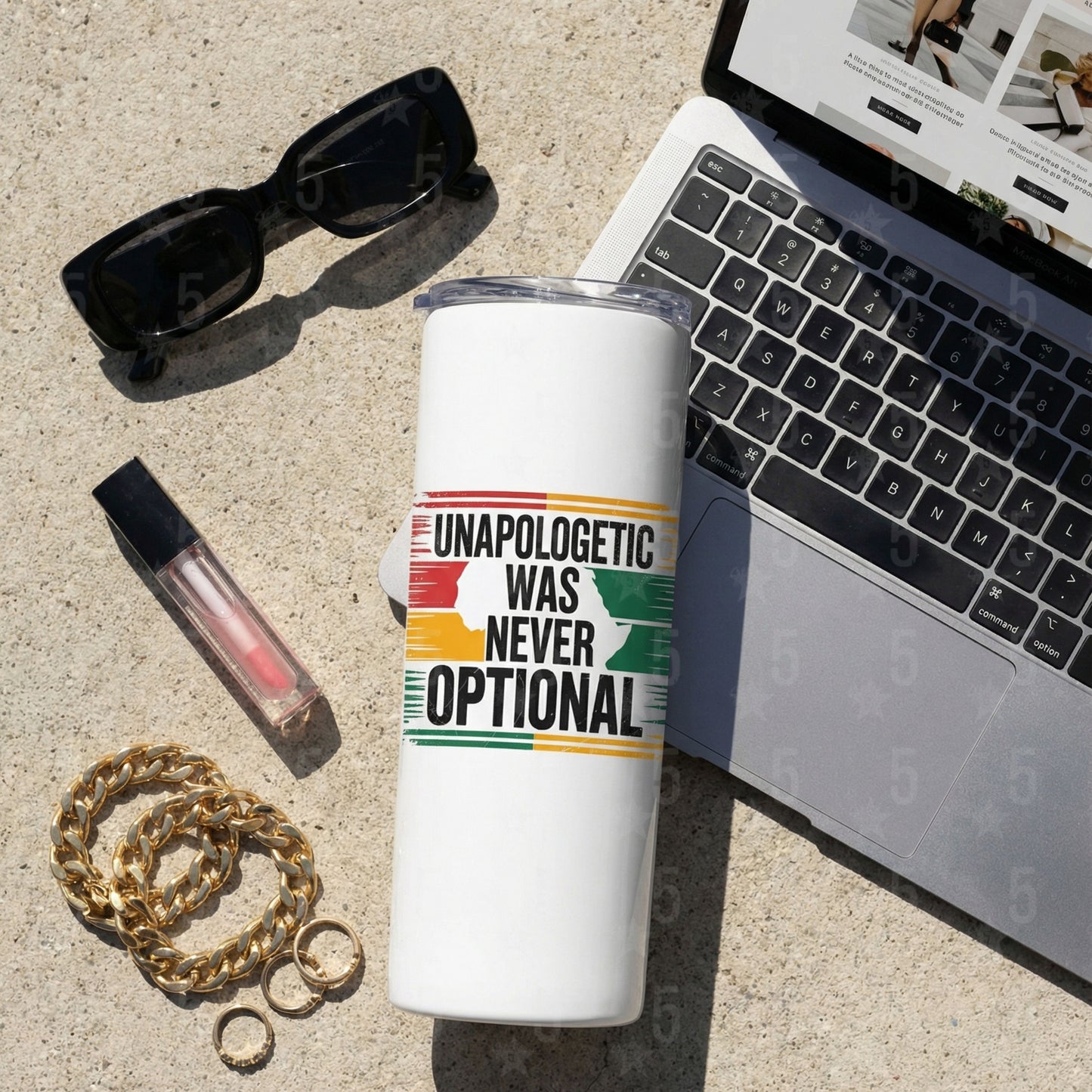 White tumbler with motivational quote next to a laptop, sunglasses, and lip gloss on a concrete surface.