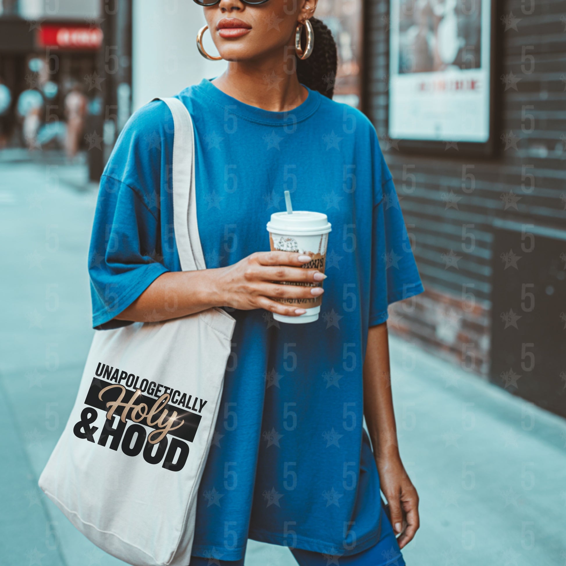 Woman holding a cup and a tote bag with text on a city street