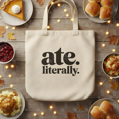 Tote bag with 'ate. literally.' text on a table with Thanksgiving food.