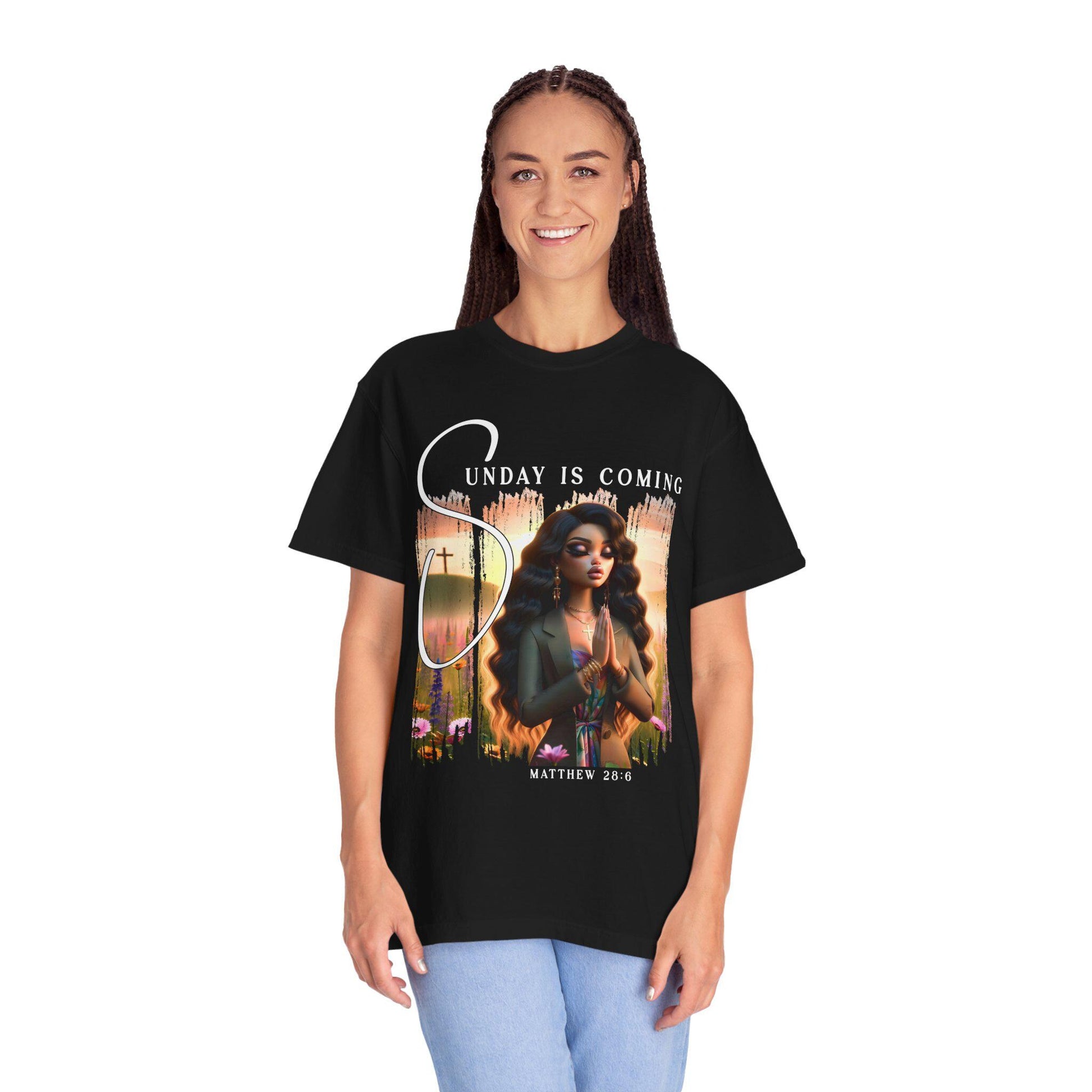 Person wearing a black t-shirt with a sunday is coming design and text on a white background