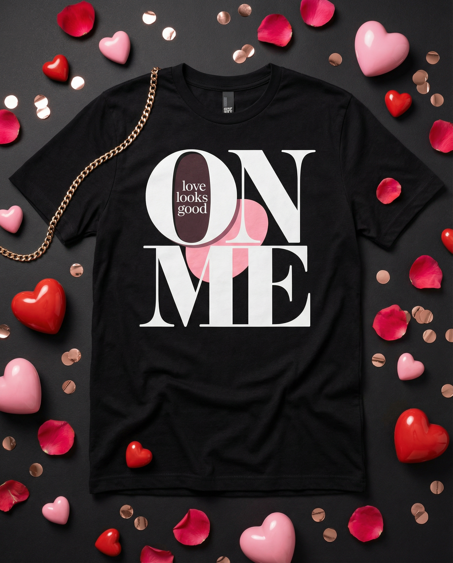 Black t-shirt with 'love looks good on me' text surrounded by heart-shaped objects on a dark background