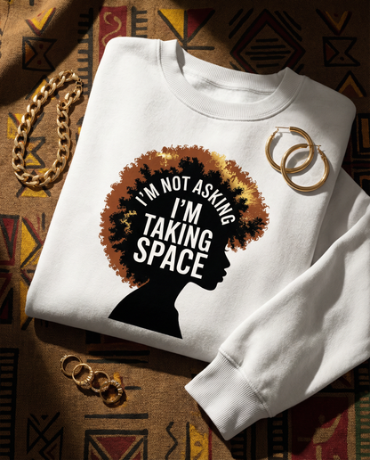 White sweatshirt with a graphic design and text on a patterned fabric background